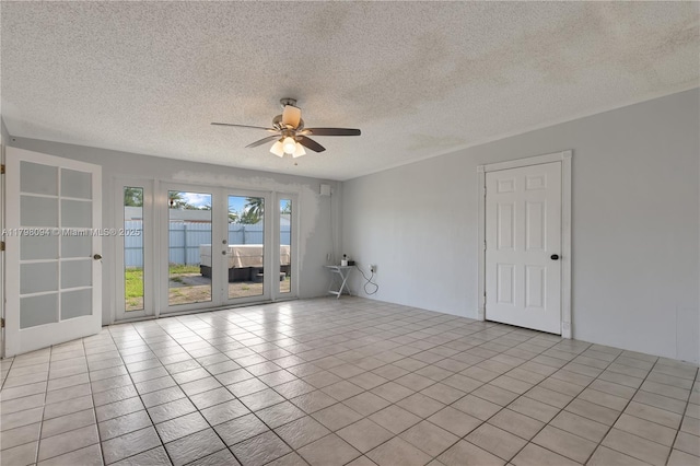 unfurnished room featuring french doors, ceiling fan, and a textured ceiling