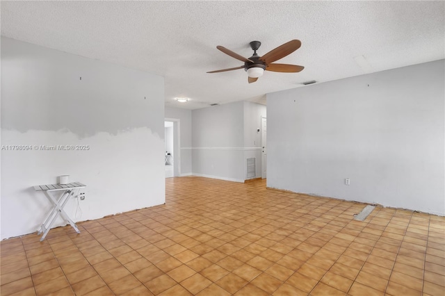 spare room featuring a ceiling fan and a textured ceiling