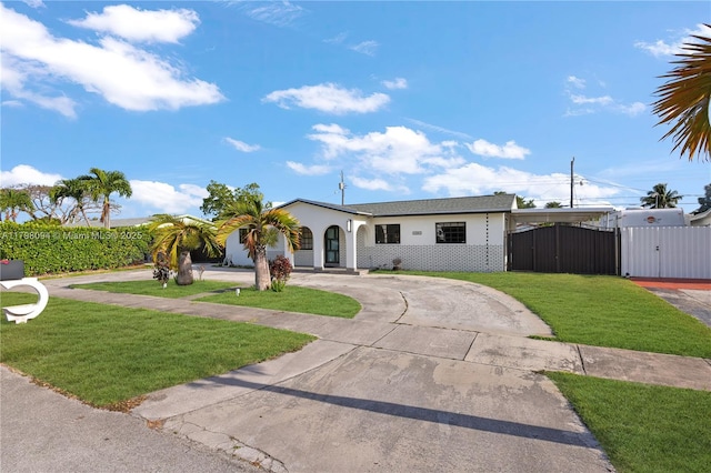view of front of home with curved driveway and a gate