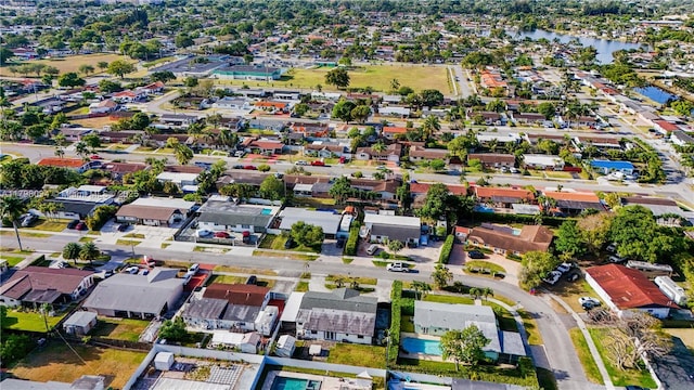 aerial view of property's location featuring nearby suburban area and a large body of water