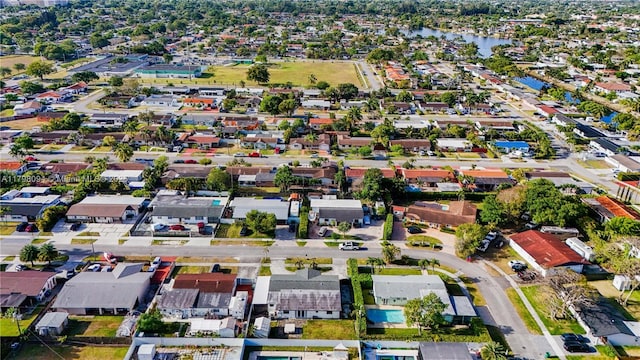 drone / aerial view featuring a water view and a residential view