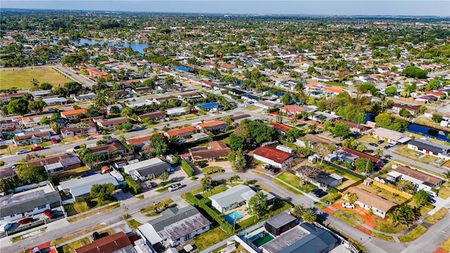 birds eye view of property with a water view and a residential view