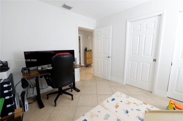 home office with light tile patterned flooring, baseboards, and visible vents