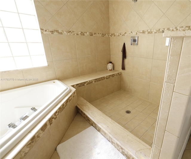 bathroom with a bath and tiled shower