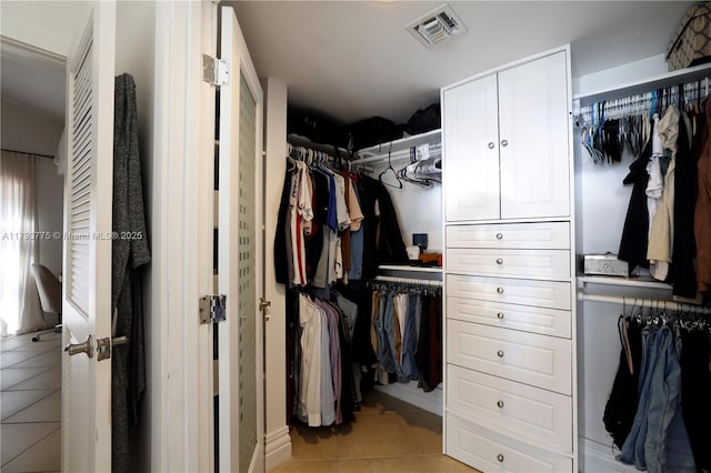 spacious closet with light tile patterned floors and visible vents