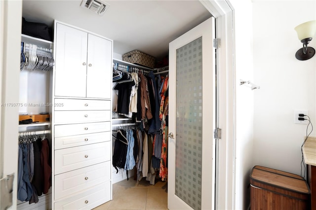 spacious closet with visible vents and light tile patterned flooring