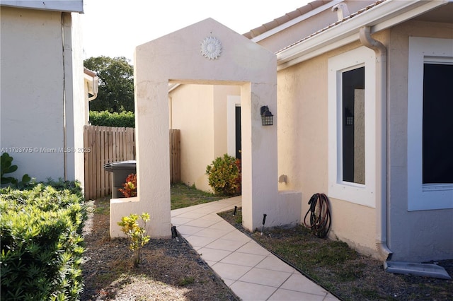 view of property exterior featuring stucco siding and fence