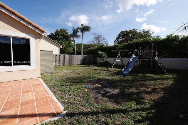 view of yard featuring a playground and a fenced backyard