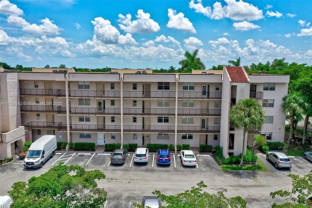 view of building exterior featuring uncovered parking