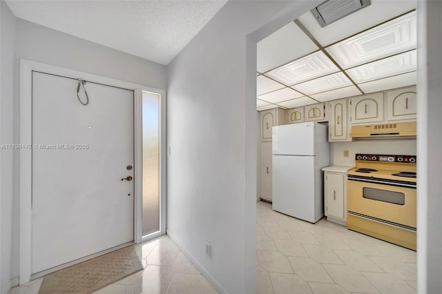 foyer with baseboards and visible vents