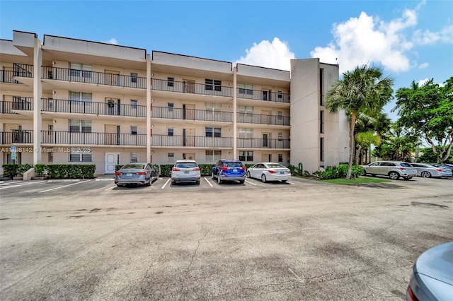view of property featuring uncovered parking