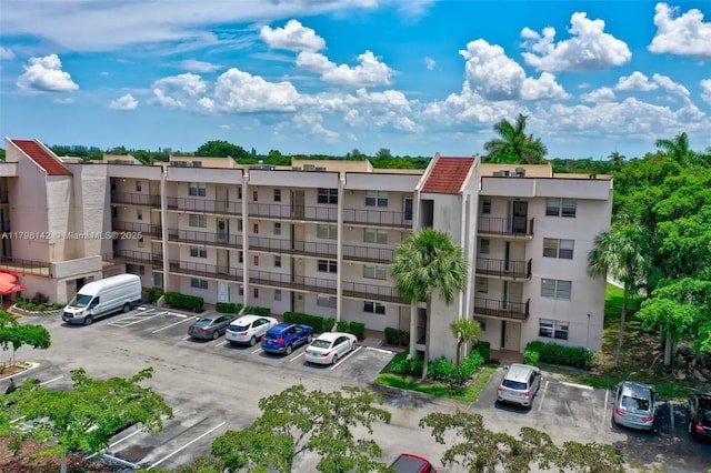 view of building exterior with uncovered parking