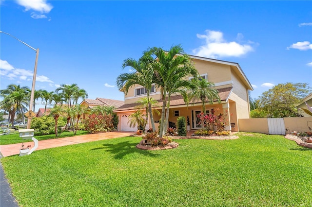 631 NW 205th Ave, Pembroke Pines, FL 33029 - view of front of home with an attached garage, stucco siding, fence, concrete driveway, and a front lawn