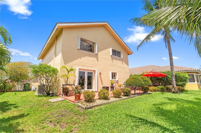 631 NW 205th Ave, Pembroke Pines, FL 33029 - back of property featuring a lawn, a patio area, stucco siding, and french doors