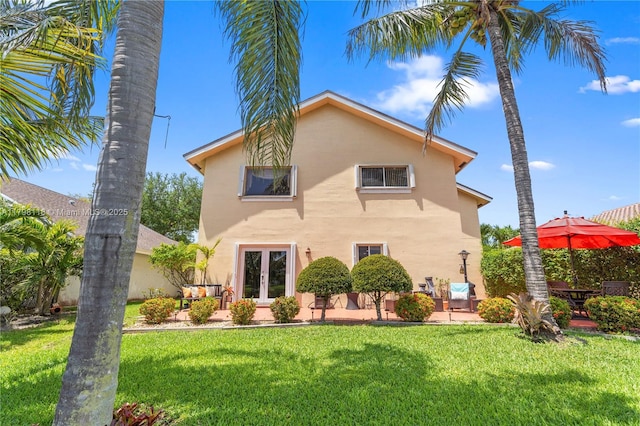 631 NW 205th Ave, Pembroke Pines, FL 33029 - back of house featuring a yard, stucco siding, french doors, and a patio