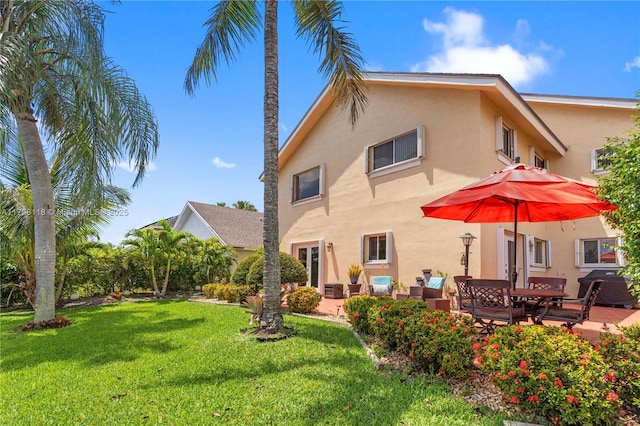 631 NW 205th Ave, Pembroke Pines, FL 33029 - rear view of house with stucco siding, a lawn, and a patio area