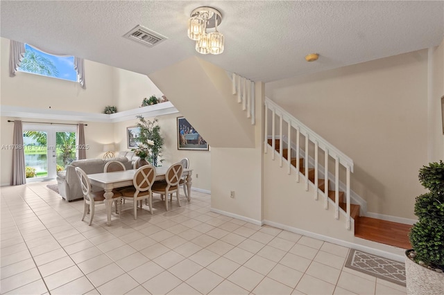 631 NW 205th Ave, Pembroke Pines, FL 33029 - dining area with stairs, a textured ceiling, visible vents, light tile patterned floors, and baseboards