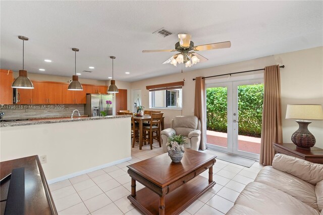 631 NW 205th Ave, Pembroke Pines, FL 33029 - living room featuring light tile patterned flooring, a wealth of natural light, a ceiling fan, and visible vents
