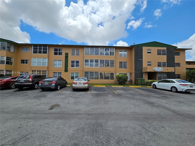 view of property with uncovered parking