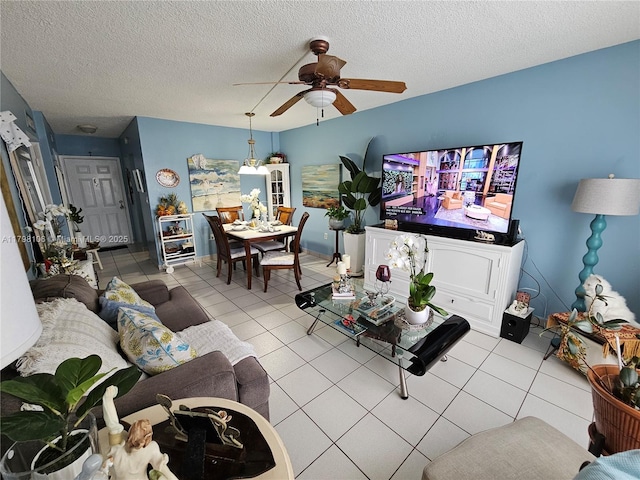 tiled living room featuring ceiling fan and a textured ceiling