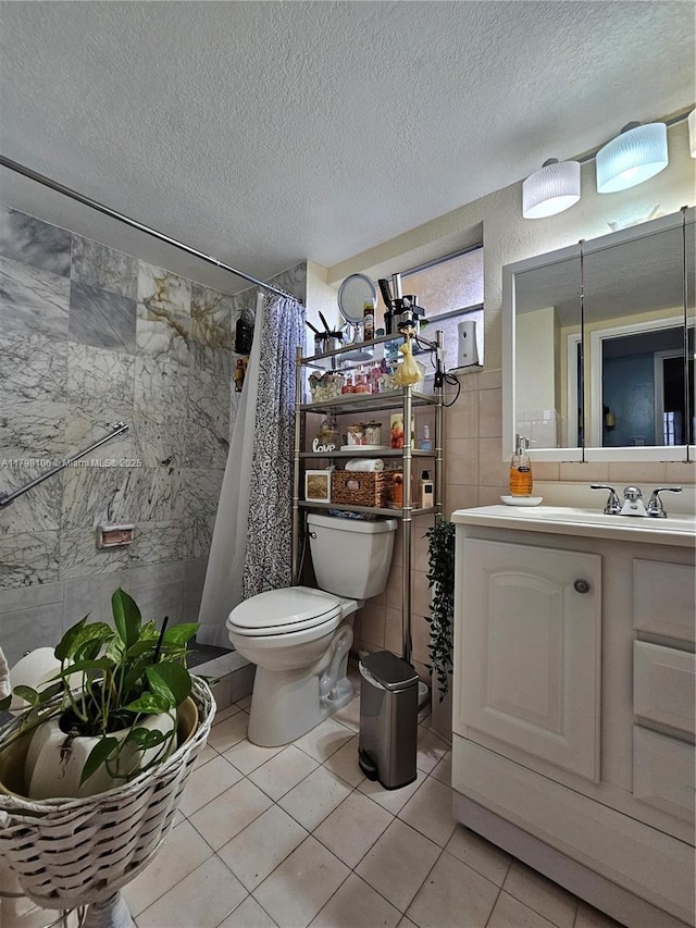 full bath with tile patterned flooring, toilet, a textured ceiling, and tile walls