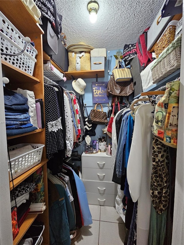 walk in closet with tile patterned flooring