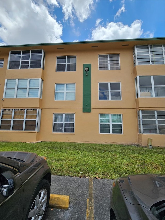 view of property featuring uncovered parking
