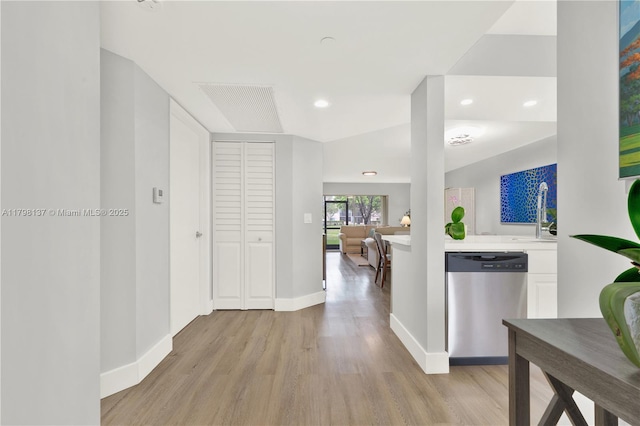 corridor featuring baseboards, light wood-style floors, and recessed lighting