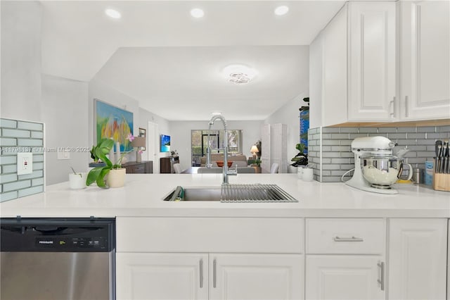kitchen featuring dishwasher, a sink, white cabinetry, backsplash, and light countertops