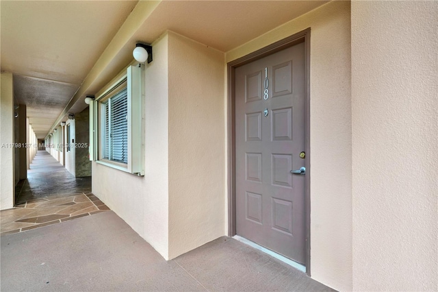 property entrance featuring stucco siding