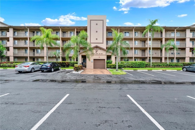 view of apartment building / complex with uncovered parking