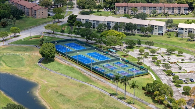 aerial view of a nearby body of water, apartment complex, and a local golf course