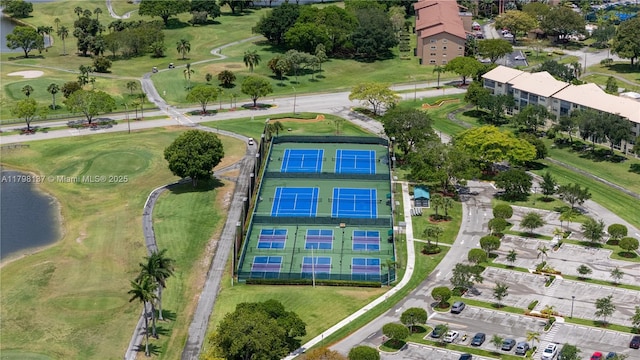 aerial view of property's location with a nearby body of water and a golf club