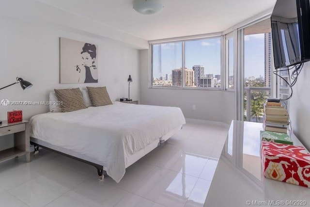 tiled bedroom featuring baseboards