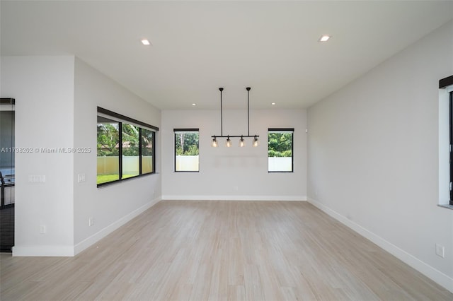 unfurnished room featuring light wood-style floors, recessed lighting, and plenty of natural light