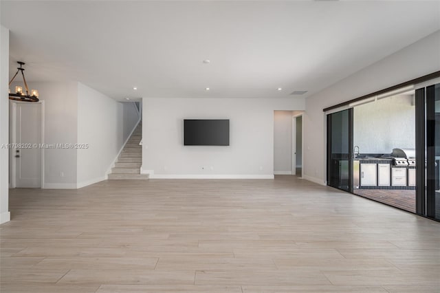unfurnished living room featuring baseboards, recessed lighting, and light wood-type flooring