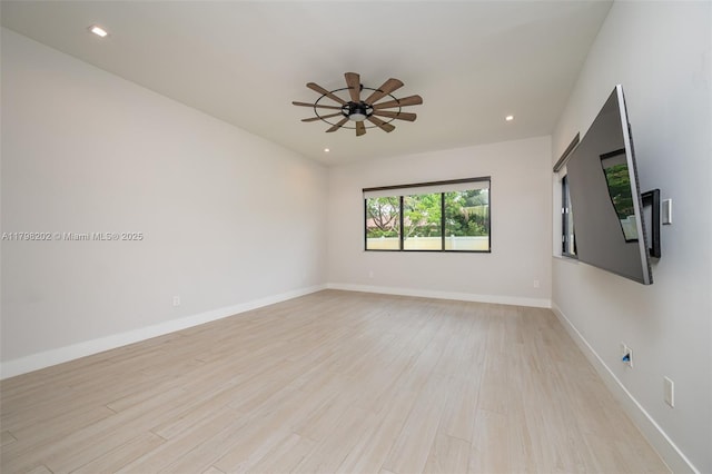empty room with light wood finished floors, baseboards, ceiling fan, and recessed lighting