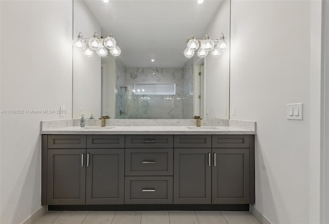 bathroom with a sink, double vanity, a marble finish shower, and baseboards