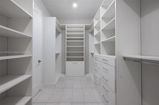 walk in closet with light tile patterned flooring