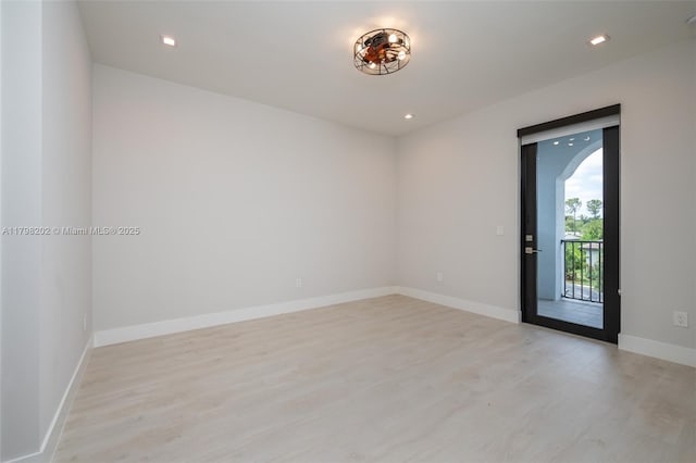 empty room featuring light wood-style flooring, baseboards, and recessed lighting