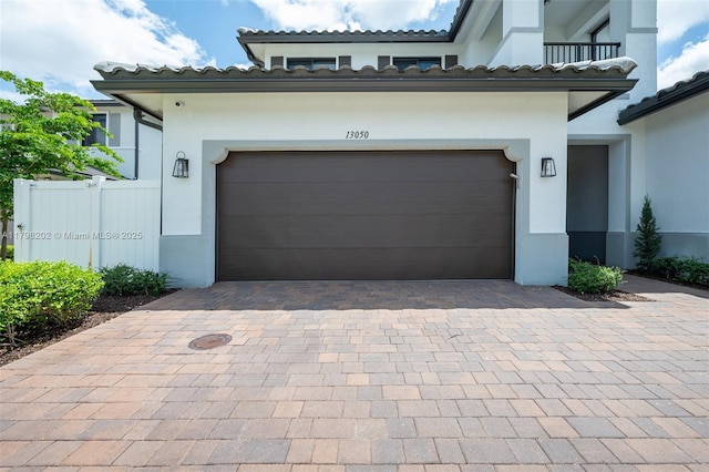 garage with driveway and fence
