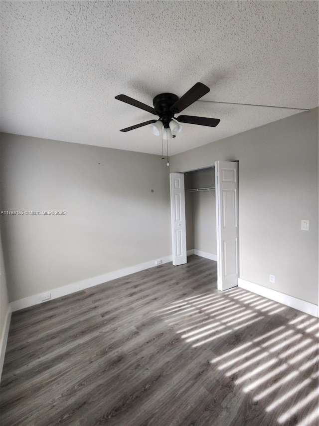 1401 SW 128th Ter Unit 305H, Pembroke Pines, FL 33027 - unfurnished bedroom with dark wood-type flooring, a textured ceiling, a closet, and a ceiling fan