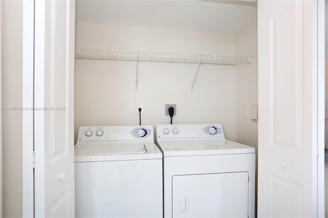 washroom featuring washing machine and dryer and laundry area