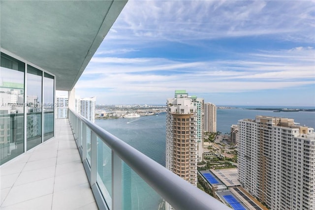balcony with a water view and a city view
