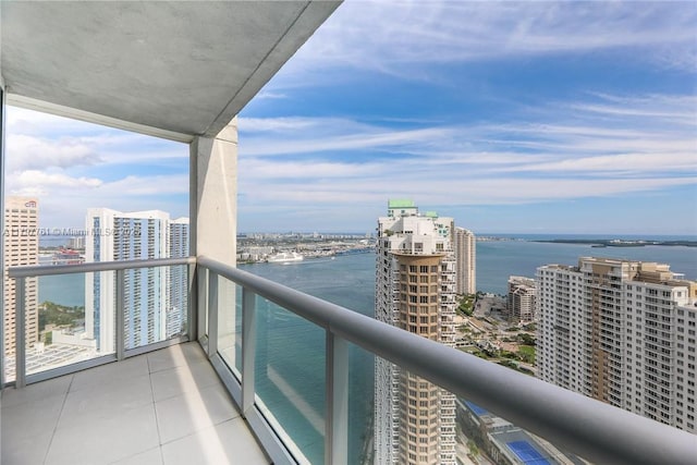balcony featuring a city view and a water view
