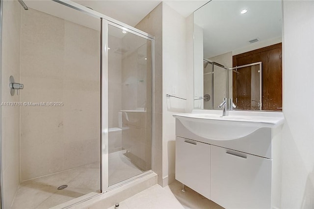 full bath with a shower stall, vanity, and tile patterned flooring