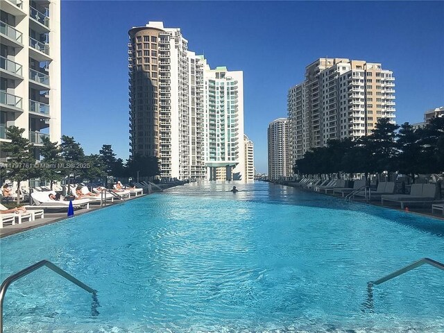 view of swimming pool with a view of city