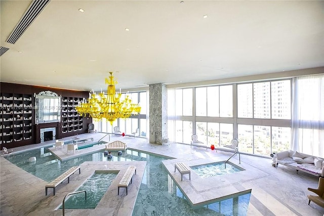 view of pool with a chandelier and a fireplace