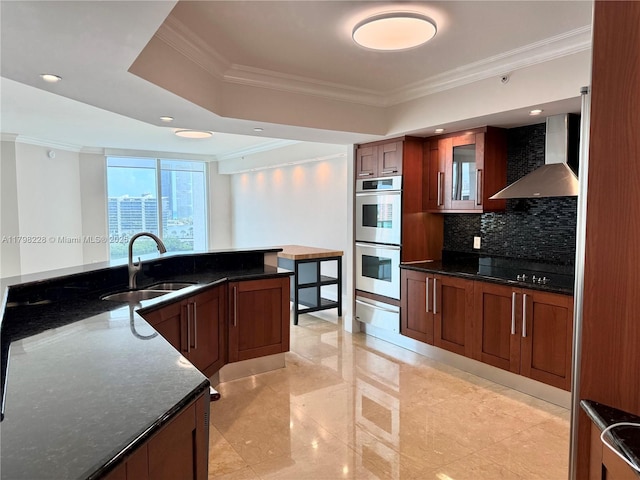 kitchen featuring stainless steel double oven, a sink, crown molding, wall chimney exhaust hood, and a warming drawer