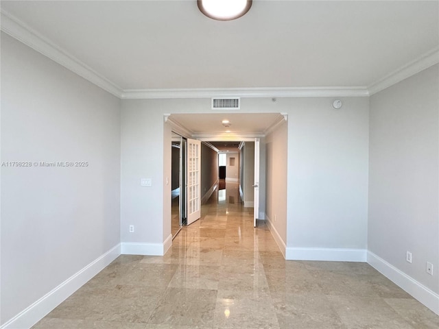 corridor with marble finish floor, visible vents, baseboards, and ornamental molding